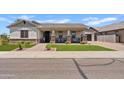 Inviting single-story home with beautiful landscaping and a cozy front porch at 1500 E Sagittarius Pl, Chandler, AZ 85249