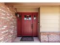 Stylish red front door with glass accents and classic hardware, framed by brick and siding at 1735 E Hope St, Mesa, AZ 85203