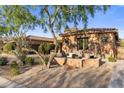 Outdoor seating area with lush landscaping and stone accents, perfect for relaxing at 18127 N 98Th Way, Scottsdale, AZ 85255