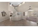 Open foyer with tile flooring, high ceilings, staircase and decorative accents, leading to various rooms at 2036 E Carob Dr, Chandler, AZ 85286