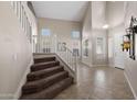 Bright foyer featuring tile flooring, soaring ceilings, staircase and natural light from multiple windows at 2036 E Carob Dr, Chandler, AZ 85286