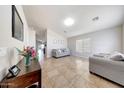 Bright living room with tile floors, neutral paint, and comfortable seating, creating a welcoming atmosphere at 2716 W Sunland Ave, Phoenix, AZ 85041