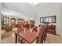 Spacious dining room with large wooden table and chairs, open to the living area at 3214 N 138Th Dr, Avondale, AZ 85392
