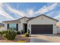 Inviting single-story home featuring a well-maintained front yard and a neutral color scheme at 37790 W Santa Clara Ave, Maricopa, AZ 85138