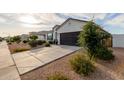 Lovely single-story home with a long driveway and desert landscaping at 37790 W Santa Clara Ave, Maricopa, AZ 85138