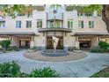 Beautiful building entrance featuring an art sculpture, fountain, and well-maintained landscaping at 3801 N Goldwater Blvd # 201, Scottsdale, AZ 85251
