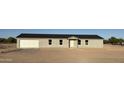 Newly constructed, single-story home featuring a gray exterior, a single-car garage, and modern windows at 5055 N Jayson Rd, Casa Grande, AZ 85194