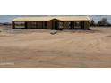 View of a house under construction, with exposed framing, and the roof, with a large dirt yard at 5055 N Jayson Rd, Casa Grande, AZ 85194