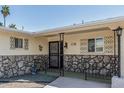 Inviting front porch with decorative ironwork and stone accents, enhancing the home's entry appeal at 6051 E Ensenada St, Mesa, AZ 85205