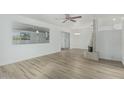 Bright living room featuring modern flooring, a brick fireplace, and ample natural light at 6051 E Ensenada St, Mesa, AZ 85205