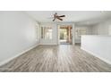 Spacious living room with wood-style floors and sliding door to patio at 6180 W Oraibi Dr, Glendale, AZ 85308