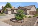 Charming single-story home showcasing desert landscaping, a two-car garage, and a well-kept front yard at 6827 W El Cortez Pl, Peoria, AZ 85383