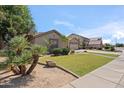 Attractive single-story home with green lawn, desert landscaping, and an attached two-car garage at 6827 W El Cortez Pl, Peoria, AZ 85383