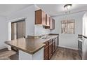 The kitchen features wood cabinets and a breakfast bar perfect for casual dining and flows into the living space at 747 S Extension Rd # 113, Mesa, AZ 85210