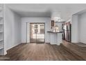 Bright living room features sliding glass doors offering outdoor views and flows into the kitchen area with stainless steel appliances at 747 S Extension Rd # 113, Mesa, AZ 85210