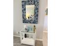 Stylish hallway with a decorative mirror and a mirrored side table with accessories at 7625 E Camelback Rd # B241, Scottsdale, AZ 85251