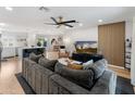 Spacious living room with an open floor plan, featuring a modern ceiling fan and hardwood floors at 7802 E Hubbell St, Scottsdale, AZ 85257