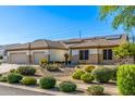 Well-maintained front exterior with desert landscaping, desert foliage, and a three-car garage at 8132 W Hatfield Rd, Peoria, AZ 85383