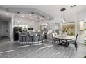 Bright eat-in kitchen featuring modern lighting, stainless appliances, and a gray accent island at 8132 W Hatfield Rd, Peoria, AZ 85383