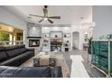 Spacious living room with a modern fireplace, floating shelves, and stylish decor at 8132 W Hatfield Rd, Peoria, AZ 85383