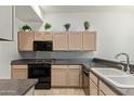 Efficient kitchen featuring neutral cabinets, a black oven, and a deep sink basin at 8270 N Hayden Rd # 2041, Scottsdale, AZ 85258