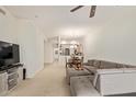 View of a carpeted living room with an expansive sectional sofa and adjacent dining area at 8270 N Hayden Rd # 2041, Scottsdale, AZ 85258