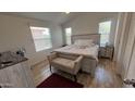 Charming bedroom features natural light, neutral tones, wood-look floors, and stylish furnishings at 9333 E University Dr # 57, Mesa, AZ 85207