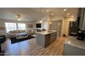 Open-concept living space flows from a large kitchen island to a cozy living area filled with natural light at 9333 E University Dr # 57, Mesa, AZ 85207