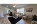 Inviting living room area featuring cozy seating, wood-look flooring, and ample natural light at 9333 E University Dr # 57, Mesa, AZ 85207