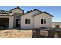 A new construction home with a light stucco exterior and black trim is being built at 9429 W Sandstone Mountain Dr, Casa Grande, AZ 85194