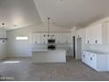 Bright, airy kitchen boasts an island, modern appliances, white cabinets, and an open floor plan at 9429 W Sandstone Mountain Dr, Casa Grande, AZ 85194
