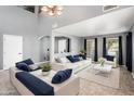 Bright living room with modern decor, high ceilings, and large windows for natural light at 9735 W Kirby Ave, Tolleson, AZ 85353