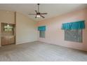 Spacious bedroom features plush carpeting, a ceiling fan, and ample natural light at 10722 W Irma Ln, Peoria, AZ 85373