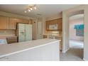 Functional kitchen featuring updated appliances, generous counter space, and access to the living area at 10722 W Irma Ln, Peoria, AZ 85373
