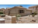 The exterior is landscaped with desert rock and desert foliage at 11531 E Persimmon Ave, Mesa, AZ 85212