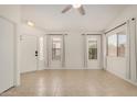 Bright living room with neutral tile flooring, lots of light, and a ceiling fan at 11531 E Persimmon Ave, Mesa, AZ 85212
