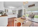Bright kitchen with modern appliances, white cabinets, and stylish dining area at 1233 E El Camino Dr, Phoenix, AZ 85020