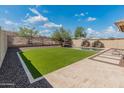 Serene backyard featuring a pristine pool, desert landscaping, and turf for low-maintenance enjoyment at 12712 W Milton Dr, Peoria, AZ 85383