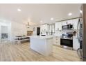 Open-concept kitchen features an island, modern appliances, and seamless flow to the dining area at 12810 N 20Th St, Phoenix, AZ 85022