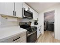 Well-equipped kitchen boasts stainless steel appliances, white countertops, and convenient access to the laundry area at 12810 N 20Th St, Phoenix, AZ 85022