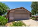 Lovely single-story home with a large driveway and mature desert landscaping at 13861 W Elm St, Surprise, AZ 85374