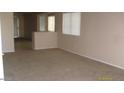 View of empty living room featuring neutral walls, plush carpet, and sunlit windows, perfect for relaxation at 13861 W Elm St, Surprise, AZ 85374