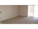 An empty living room showcasing neutral walls and plush carpeting at 13861 W Elm St, Surprise, AZ 85374
