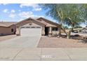 Well-maintained single-story home with a two-car garage, desert landscaping, and an inviting entrance at 16538 N Oachs Dr, Surprise, AZ 85374