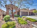 Charming home with a three car garage, desert landscaping and a stone and stucco facade at 16881 W Merrell St, Goodyear, AZ 85395
