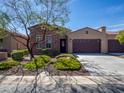 Charming home with a three car garage, desert landscaping and a stone and stucco facade at 16881 W Merrell St, Goodyear, AZ 85395