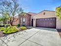 Charming home with a three car garage, desert landscaping and a stone and stucco facade at 16881 W Merrell St, Goodyear, AZ 85395