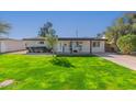 Charming single-story home with a well-manicured lawn and inviting curb appeal at 1717 W Roma Ave, Phoenix, AZ 85015