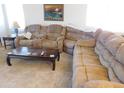 Comfortable living room featuring a plush sectional sofa and coffee table at 20282 N 104Th Ave, Peoria, AZ 85382