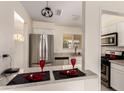Modern kitchen with stainless steel appliances and a breakfast bar at 2130 W Colter St, Phoenix, AZ 85015